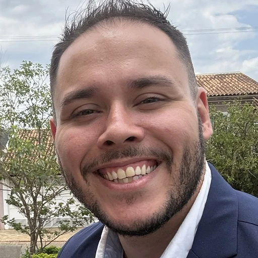 Portrait of Lucas Rossi outdoors, smiling, in a jacket and shirt