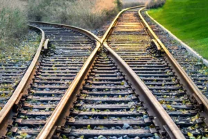 Railroad tracks diverging, the cover image for The Decision Kept Moving While We Built It